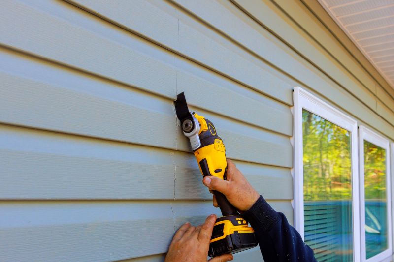 Installer Using Tools for Siding Installation